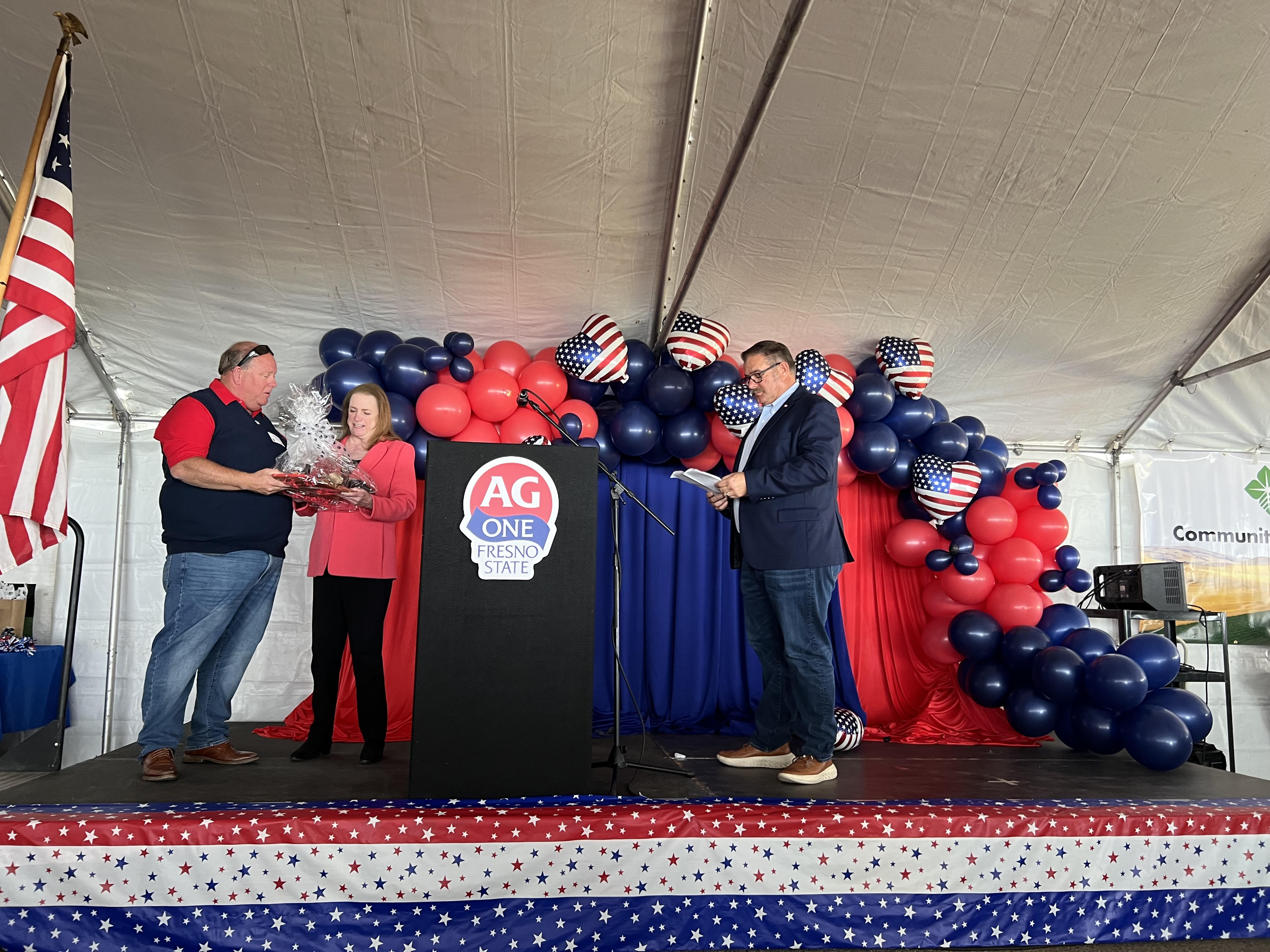 Marsha of Fresno Equipment Company recieves thank you gift from President Roger Isom