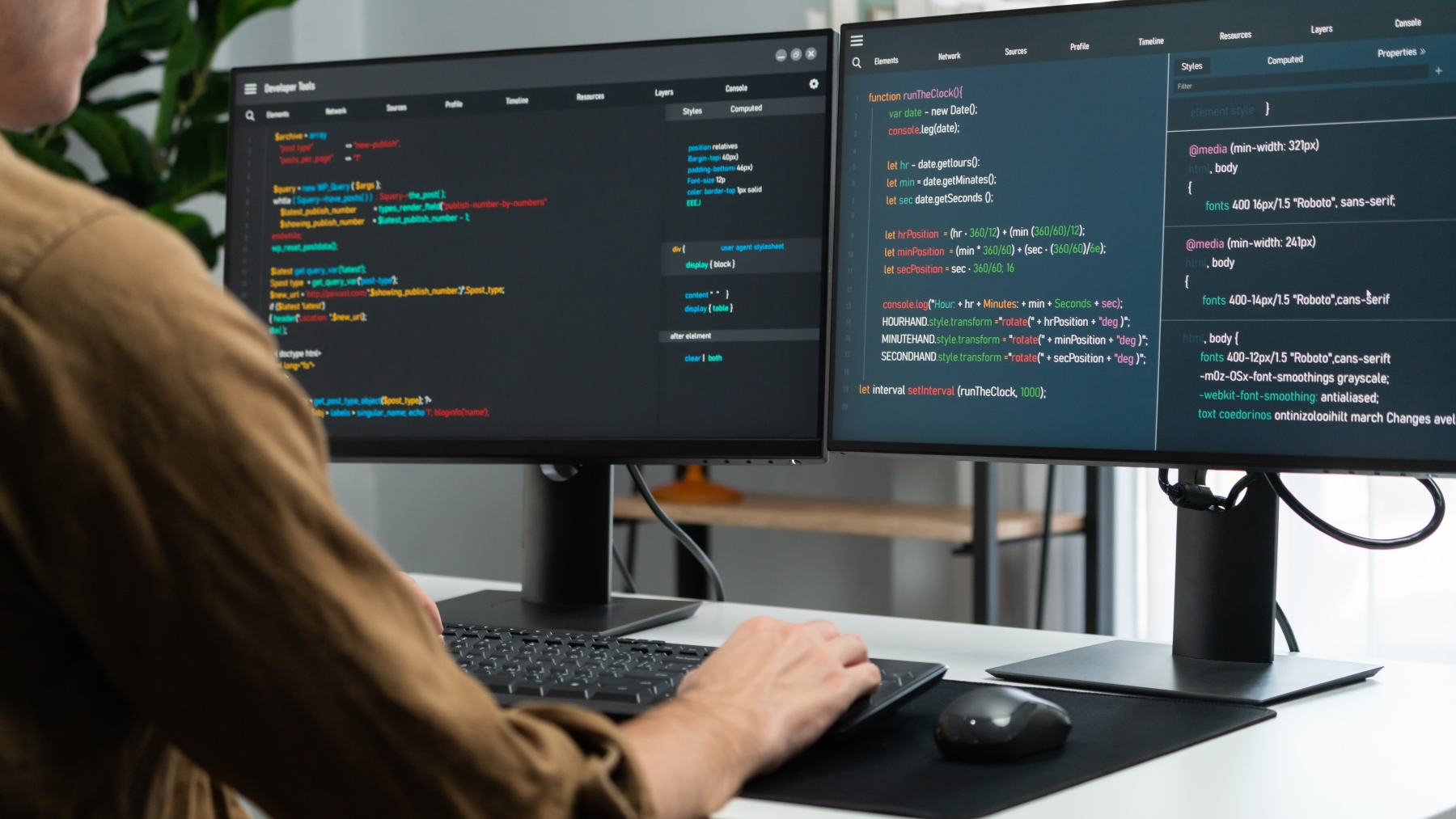 a developer coding on multiple screens