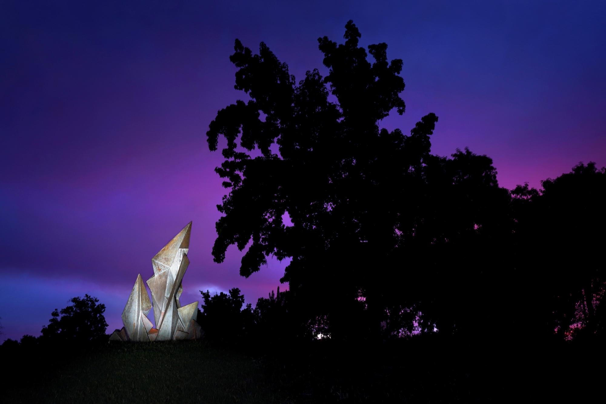 photograph of one of fresno states many sculptures with a purple sunset sky