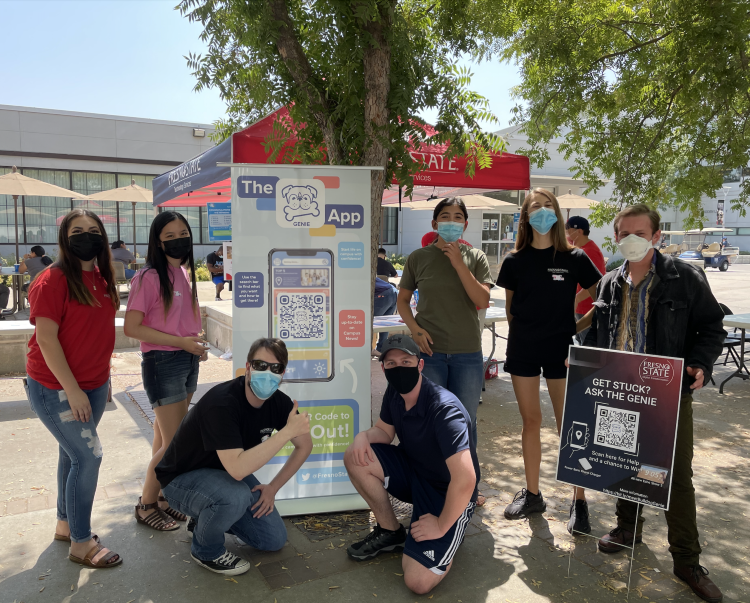 group photo of dxihub members infront of the bulldog genie banner