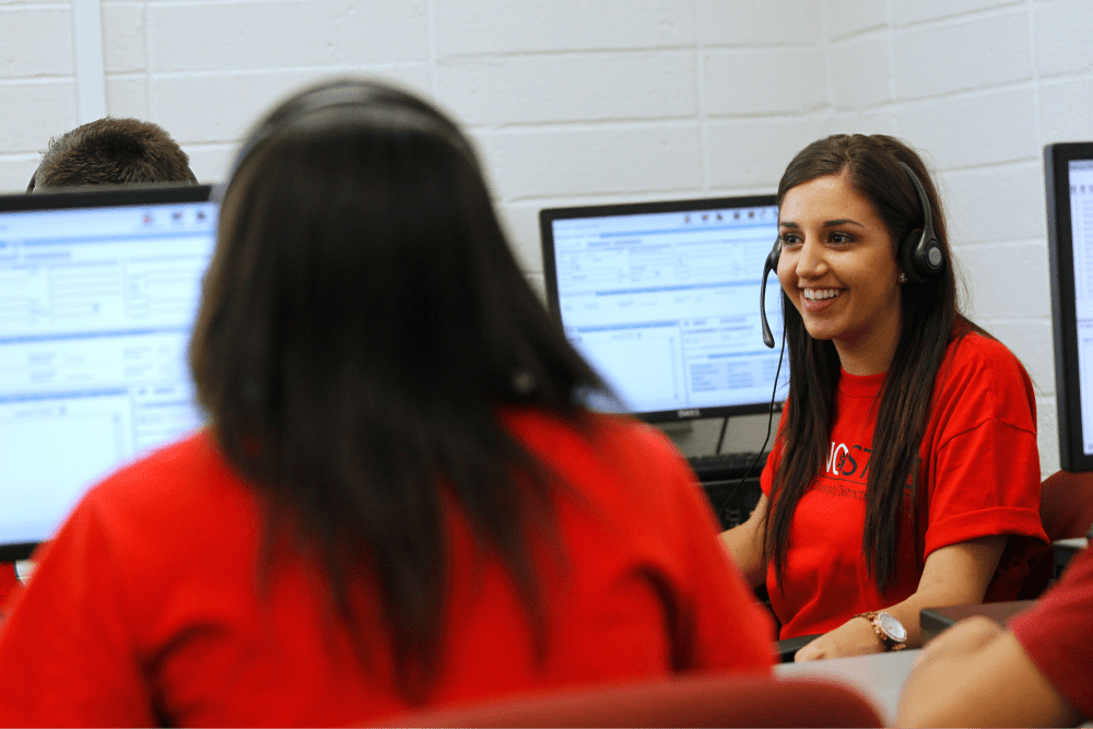 Woman with mic along side her face performing call center duties