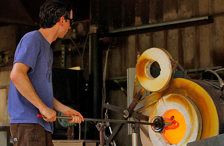 person engaged in glass blowing activity