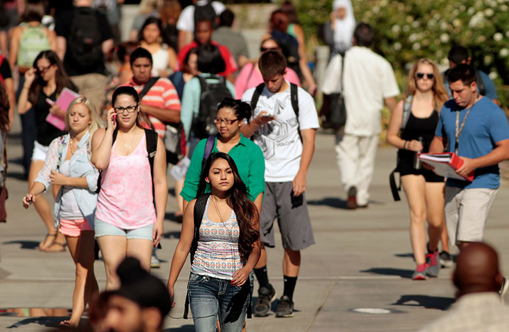 Students walk down a busy walkway on campus