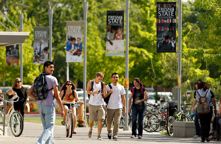 Students walking on campus near the library